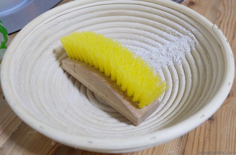 A banneton with a brush